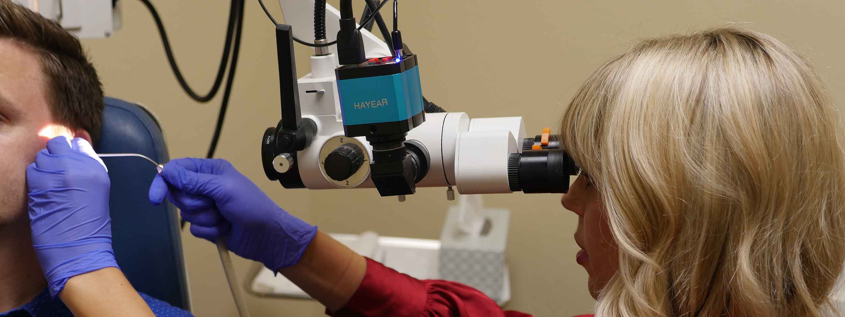 Dr. Russ working with a patient to clean their earwax