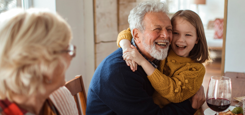 Grandparents And Granddaughter Smiling